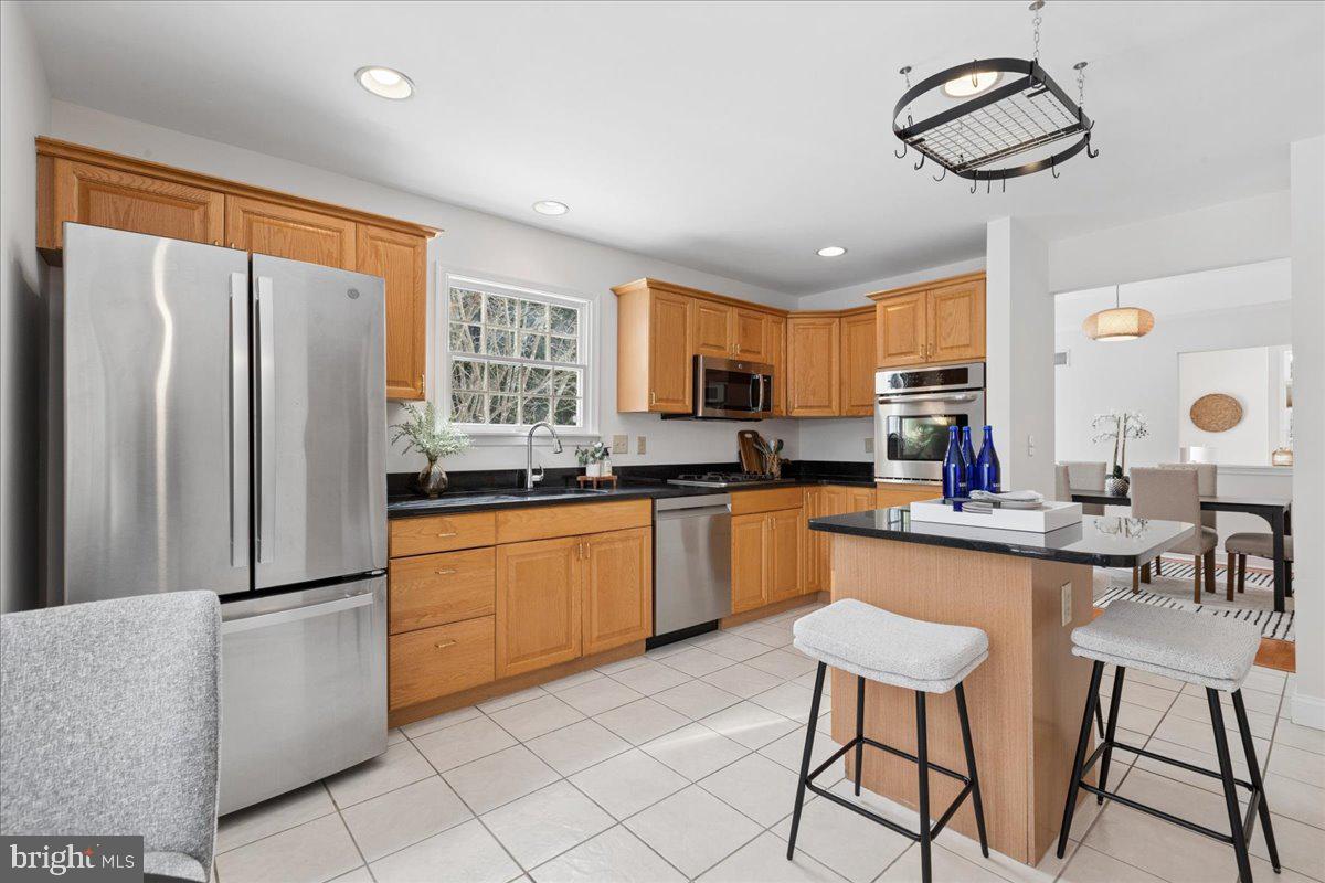 45 Hedge Row Road Princeton, NJ 08540 - Photo 6 of 29 a kitchen with stainless steel appliances granite countertop a refrigerator a sink dishwasher a dining table and chairs with wooden floor