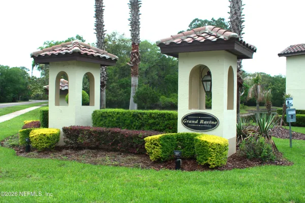 a view of a garden with an iron gate