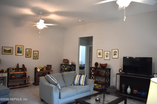 a living room with furniture and a flat screen tv