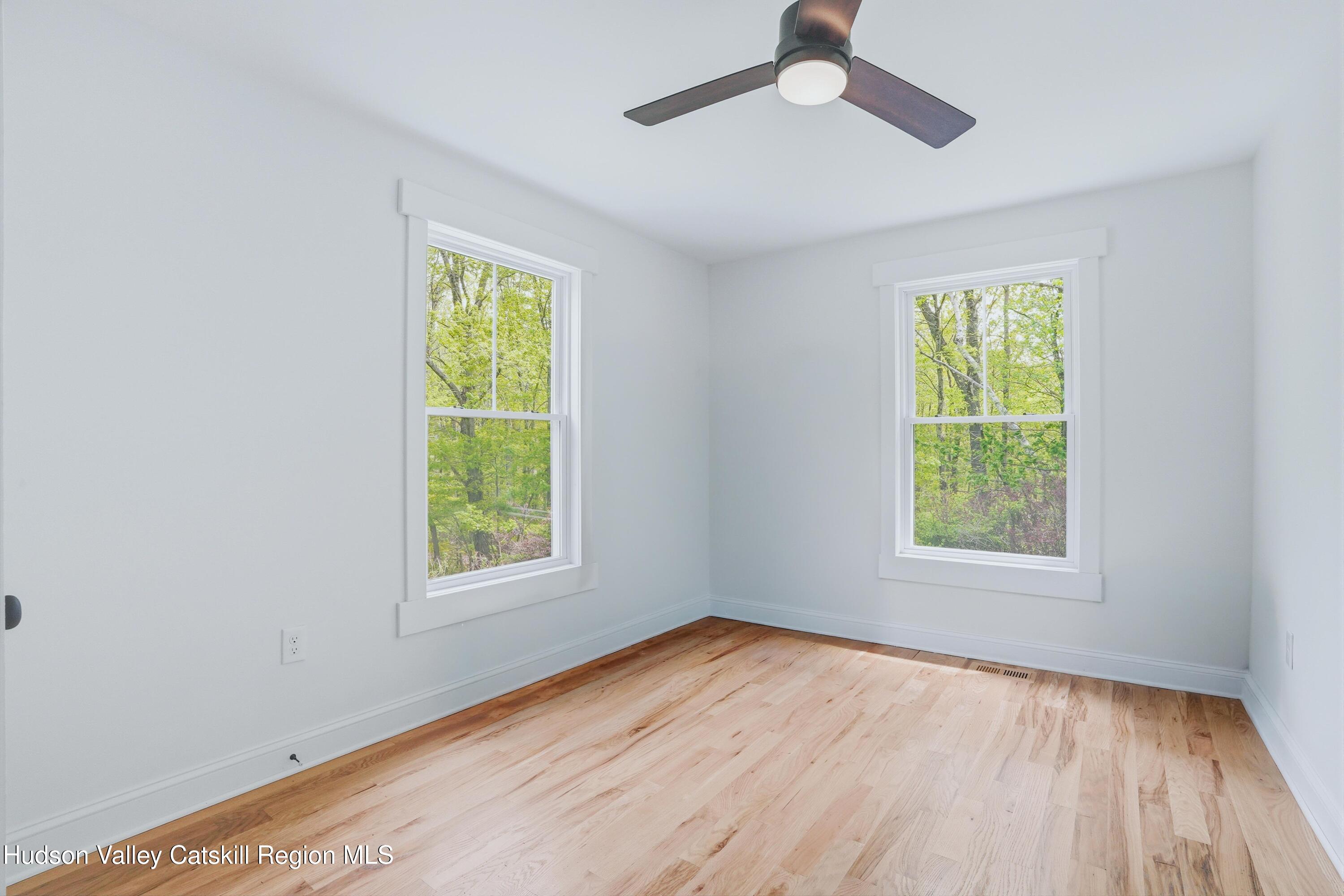 757 Taborton Road Sand Lake, NY 12153 - Photo 16 of 32 a view of an empty room with wooden floor and a window