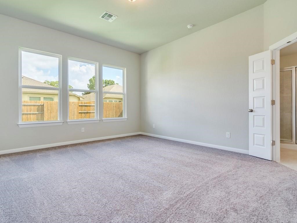 270 Rimrock Court Bastrop, TX 78602 - Photo 17 of 34 The primary suite is a true retreat, complete with a large walk-in closet, dual vanity, and walk-in shower.