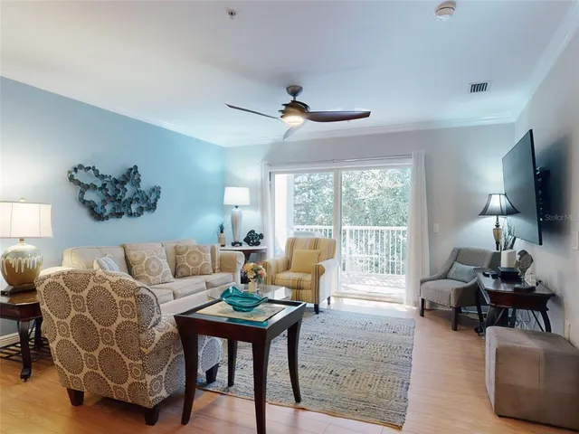 a living room with furniture flat screen tv and wooden floor