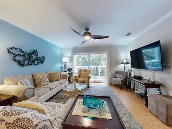 a living room with furniture a rug and a lamp