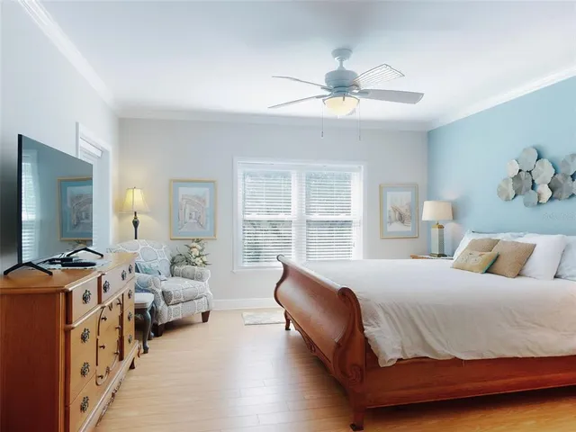 a spacious bedroom with a bed and a chandelier