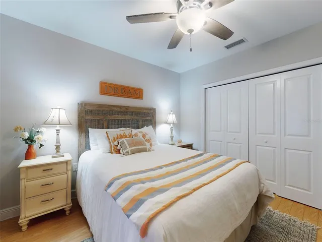 a bedroom with a large bed and a tv