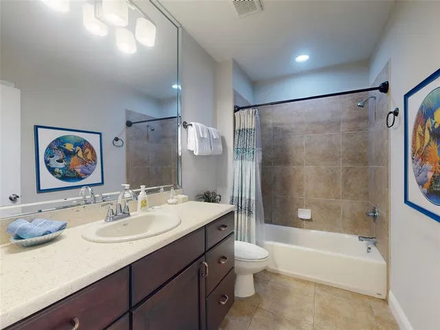 a bathroom with a sink double vanity granite tub shower and a mirror