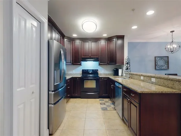 a kitchen with a sink a counter space and cabinets