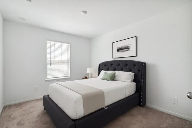 a bedroom with a bed and window