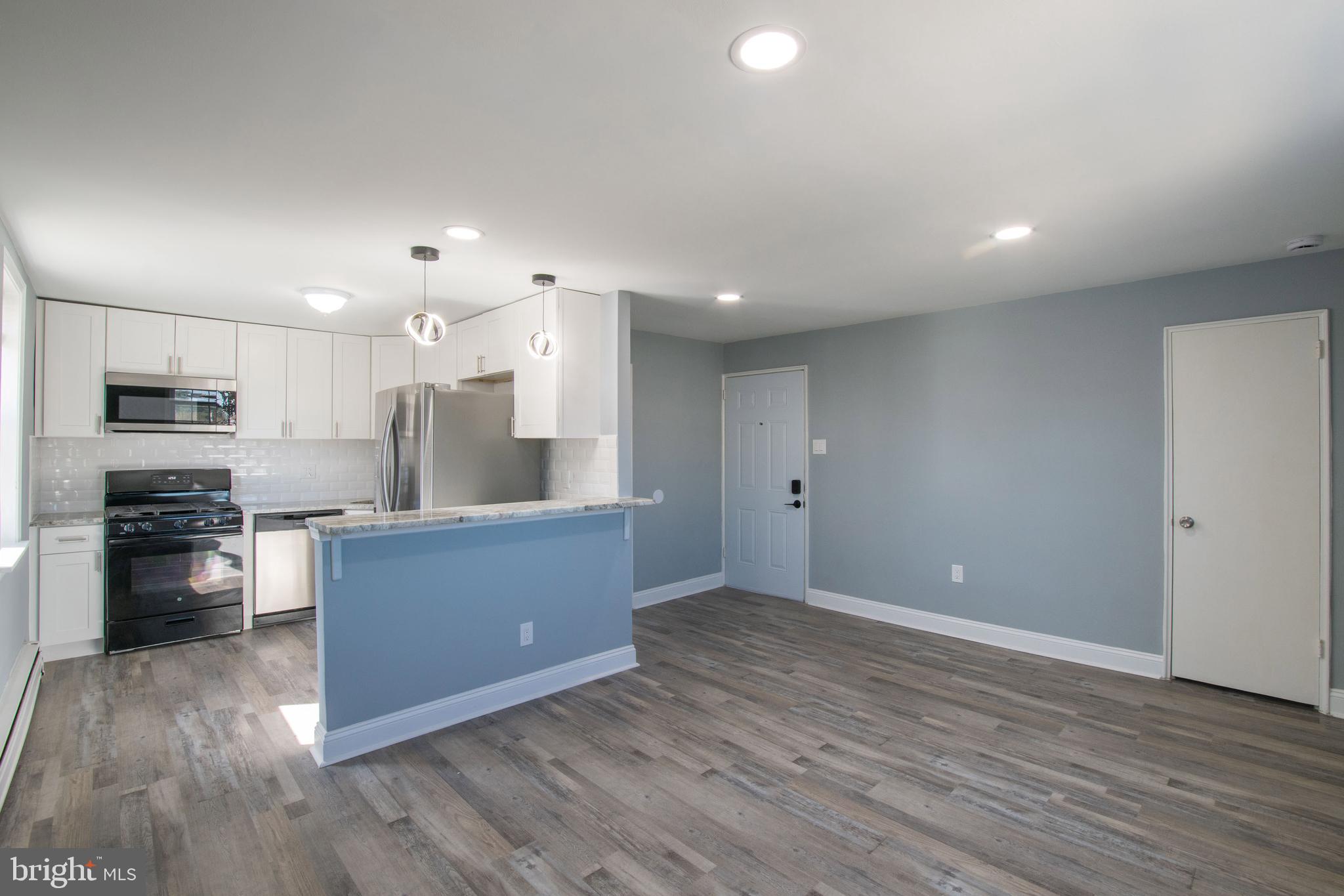 5905 Houghton Street, Unit 2 Philadelphia, PA 19128 - Photo 1 of 14 a kitchen with stainless steel appliances granite countertop a refrigerator and a stove top oven