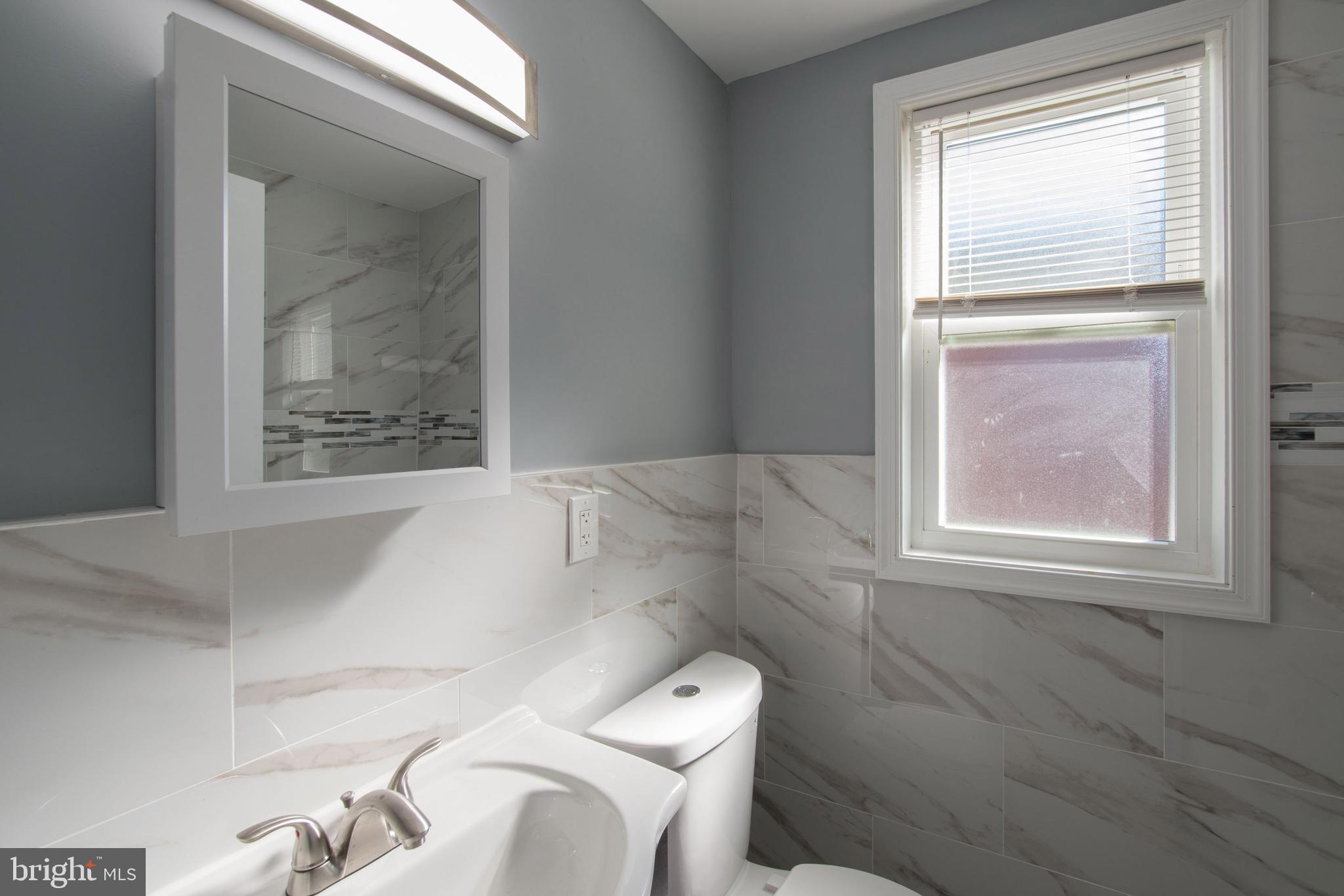 5905 Houghton Street, Unit 2 Philadelphia, PA 19128 - Photo 11 of 14 a bathroom with a toilet and a sink