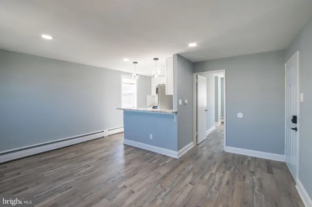 a view of a kitchen with wooden floor and a sink