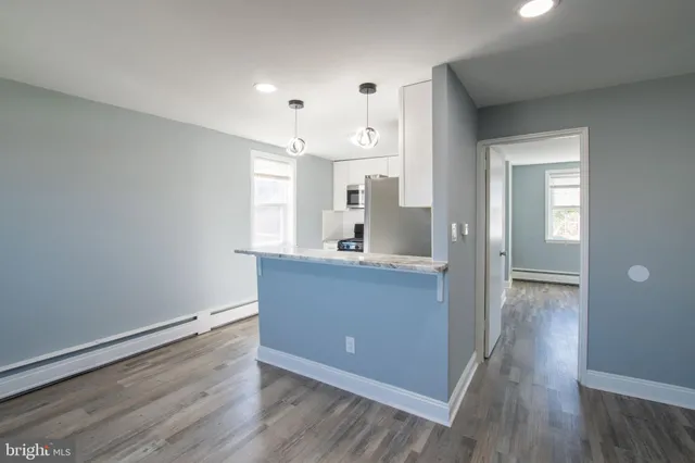 a view of kitchen with sink and wooden floor