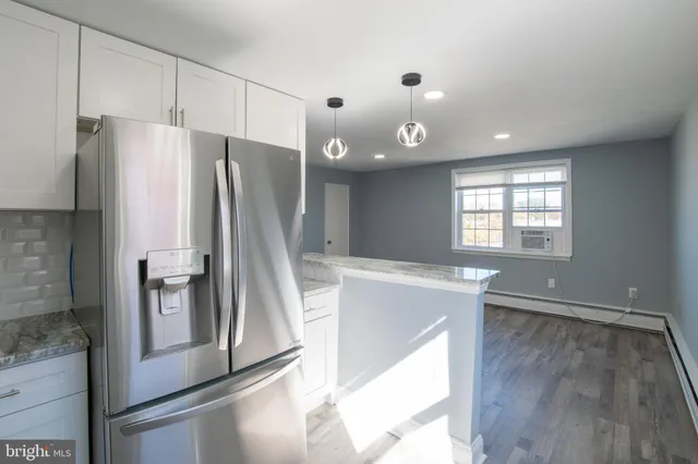 a kitchen with stainless steel appliances granite countertop a refrigerator and a sink