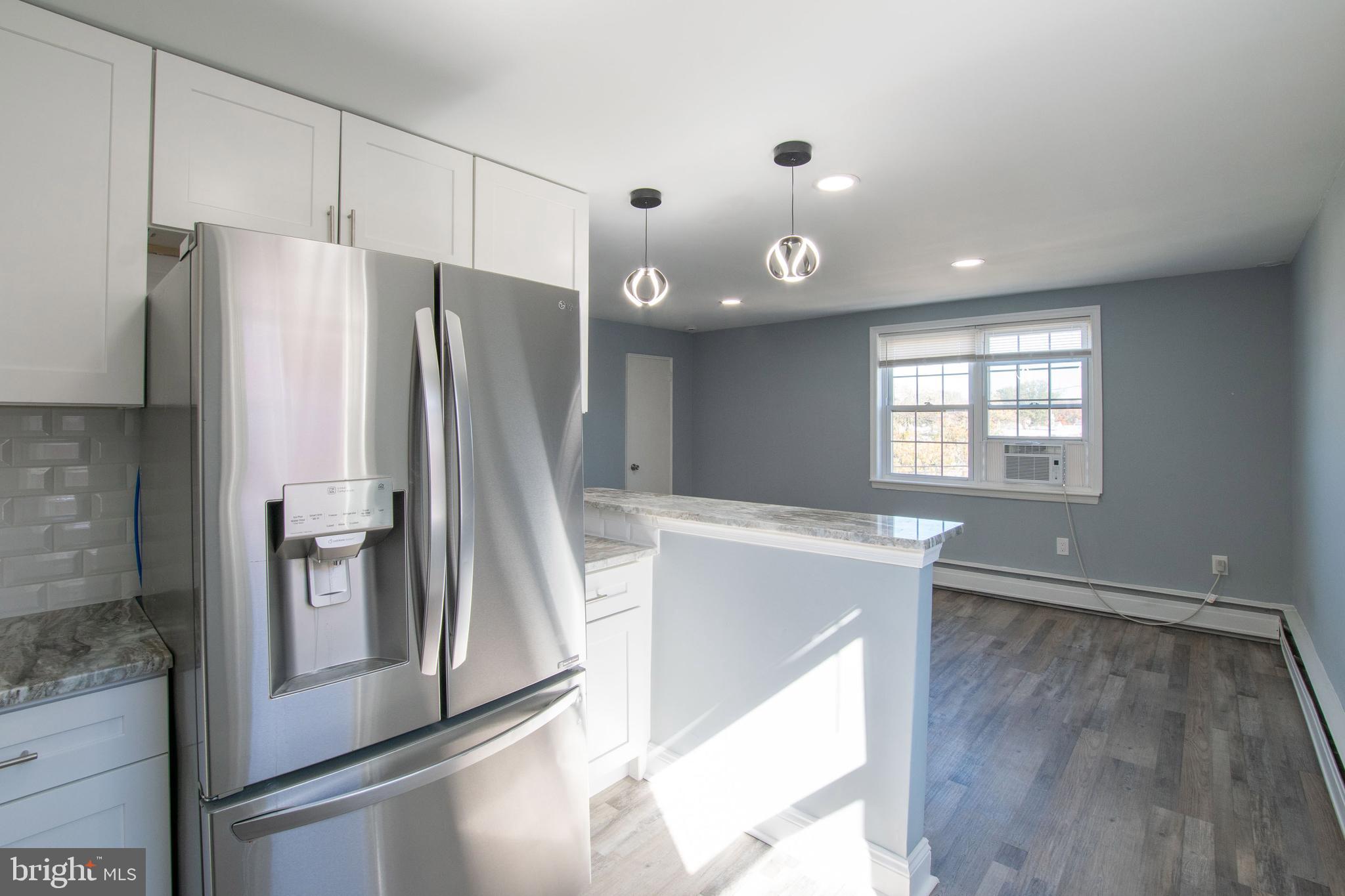 5905 Houghton Street, Unit 2 Philadelphia, PA 19128 - Photo 6 of 14 a kitchen with stainless steel appliances granite countertop a refrigerator and a sink
