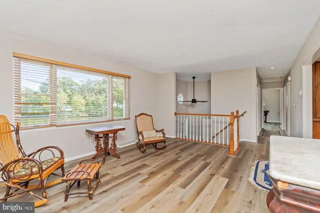 a view of a room with wooden floor and windows