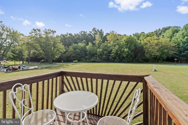 a view of a balcony with wooden floor and outdoor seating