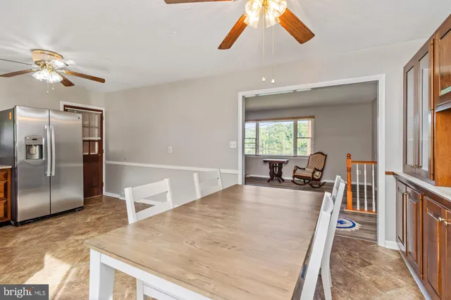 a kitchen with stainless steel appliances granite countertop a refrigerator a sink a stove and island