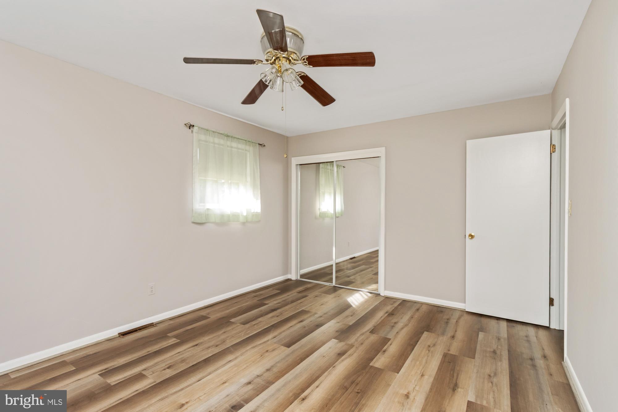 3622 Claires Lane Baltimore, MD 21220 - Photo 28 of 43 a view of empty room with wooden floor and fan