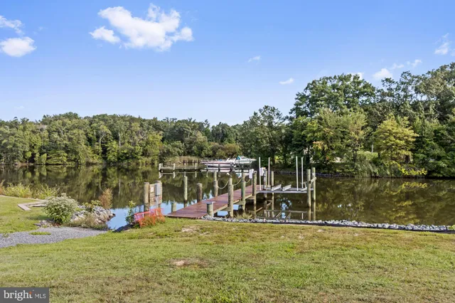 a view of a house with a swimming pool and a yard