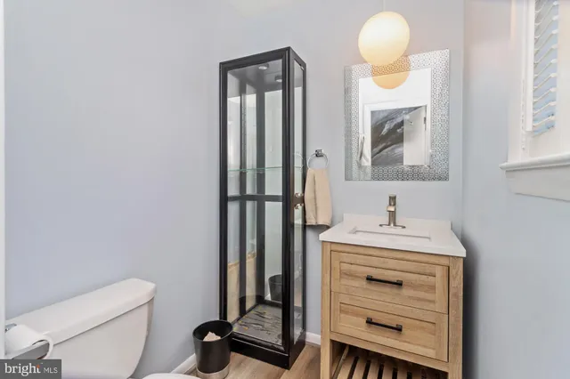 a bathroom with a toilet a sink and mirror
