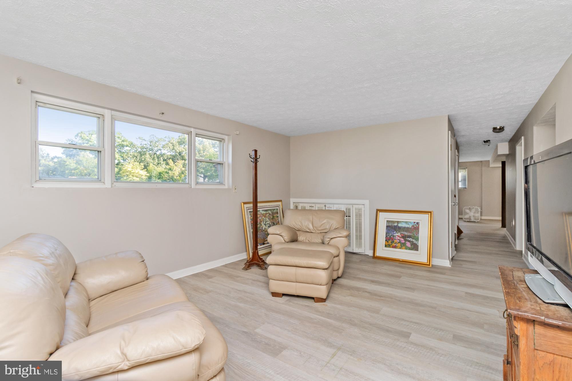 3622 Claires Lane Baltimore, MD 21220 - Photo 35 of 43 a living room with furniture and a flat screen tv