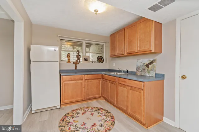 a kitchen with stainless steel appliances granite countertop a refrigerator sink and cabinets