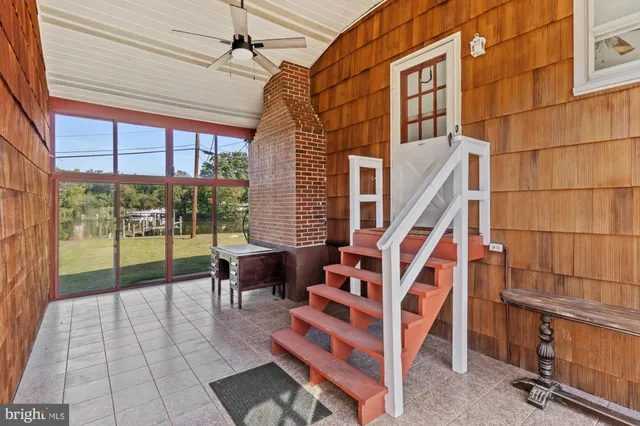 a view of entryway with a floor to ceiling window and stairs