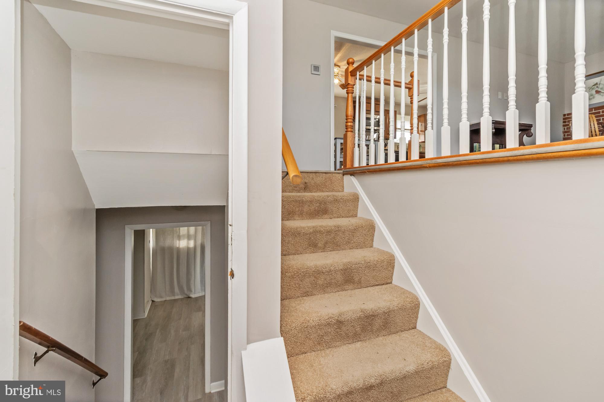 3622 Claires Lane Baltimore, MD 21220 - Photo 9 of 43 a view of staircase with lots of frames on wall and a window