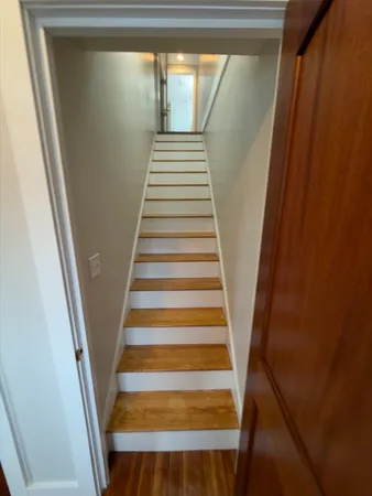 a view of an empty room and wooden floor