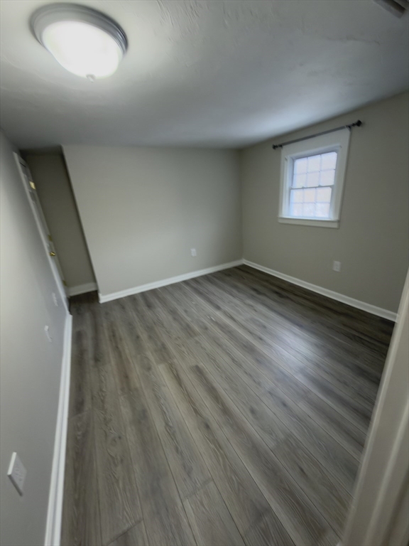 43 Sherman Street, Unit 2 Foxboro, MA 02035 - Photo 20 of 24 an empty room with wooden floor and windows