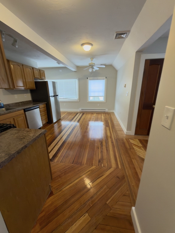 43 Sherman Street, Unit 2 Foxboro, MA 02035 - Photo 2 of 24 a bedroom with a bed and wooden floor