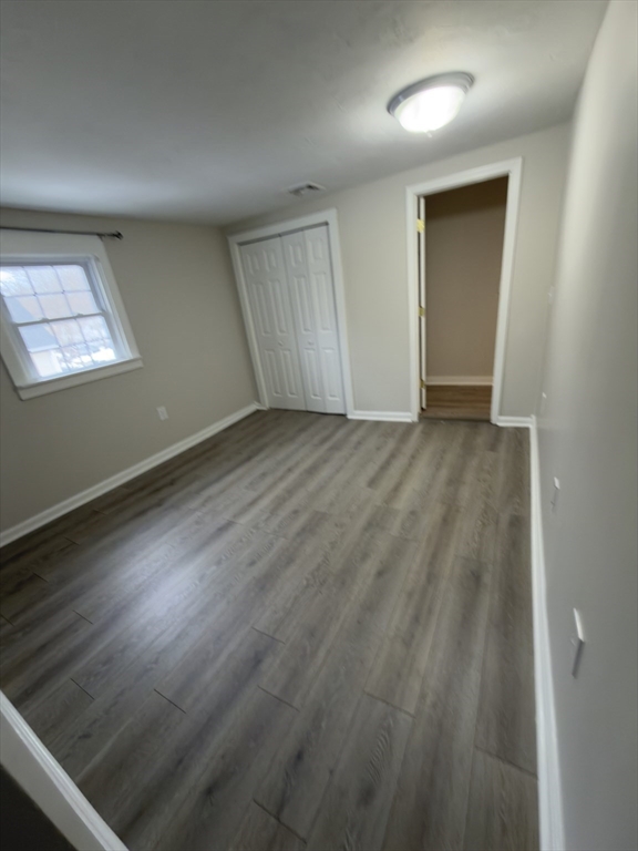 43 Sherman Street, Unit 2 Foxboro, MA 02035 - Photo 21 of 24 an empty room with wooden floor and windows