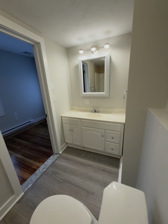 43 Sherman Street, Unit 2 Foxboro, MA 02035 - Photo 6 of 24 a bathroom with a toilet a sink and mirror