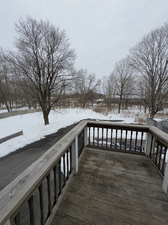 43 Sherman Street, Unit 2 Foxboro, MA 02035 - Photo 8 of 24 a balcony with wooden floor and fence