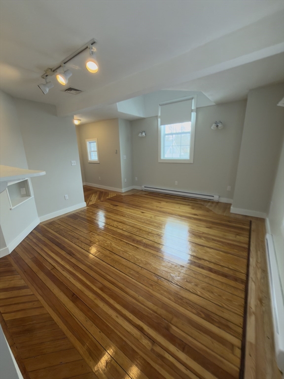 43 Sherman Street, Unit 2 Foxboro, MA 02035 - Photo 10 of 24 a view of empty room with window and wooden floor
