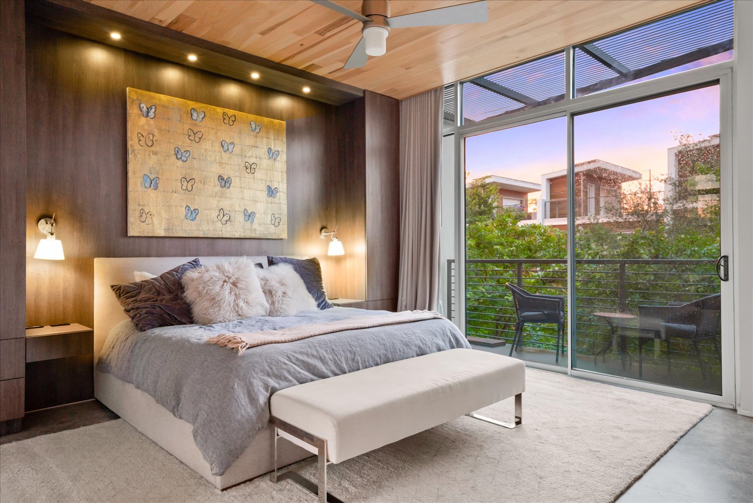2301 South 5th Street, Unit 11 Austin, TX 78704 - Photo 13 of 24 Pine ceilings rise above a custom wall unit with integrated nightstands for a refined, built-in aesthetic within the primary bedroom.