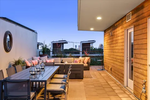 a view of a terrace with couches potted plants and sky view