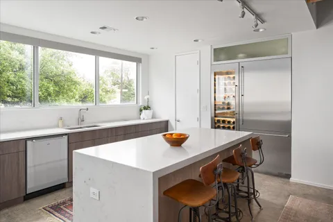 a kitchen with a sink and white cabinets