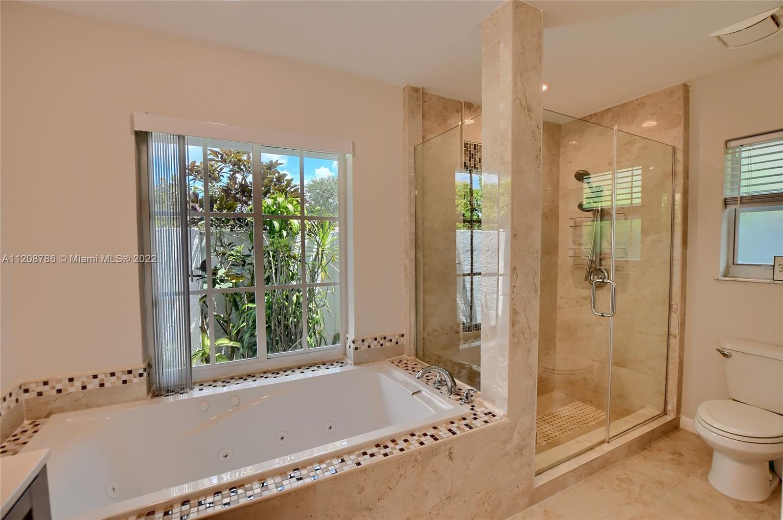 9580 Carousel Circle South Boca Raton, FL 33434 - Photo 15 of 35 a bath room with a bath tub and a shower
