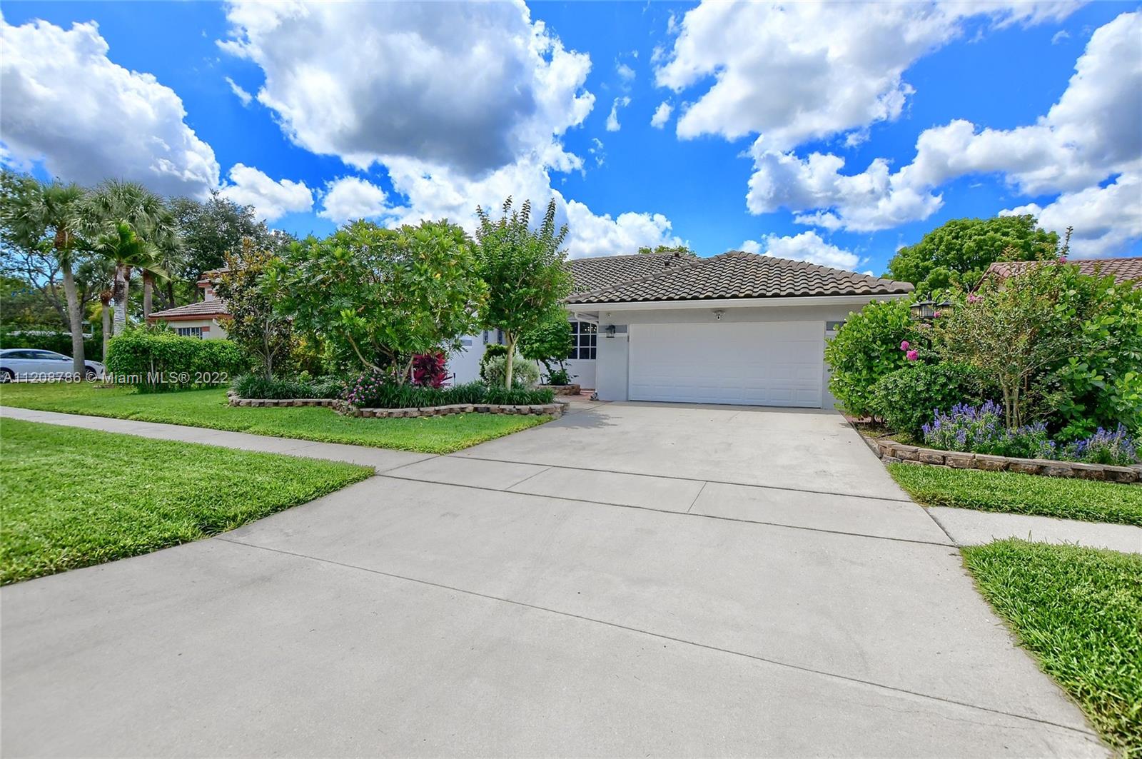 9580 Carousel Circle South Boca Raton, FL 33434 - Photo 2 of 35 a pathway of a house with a yard