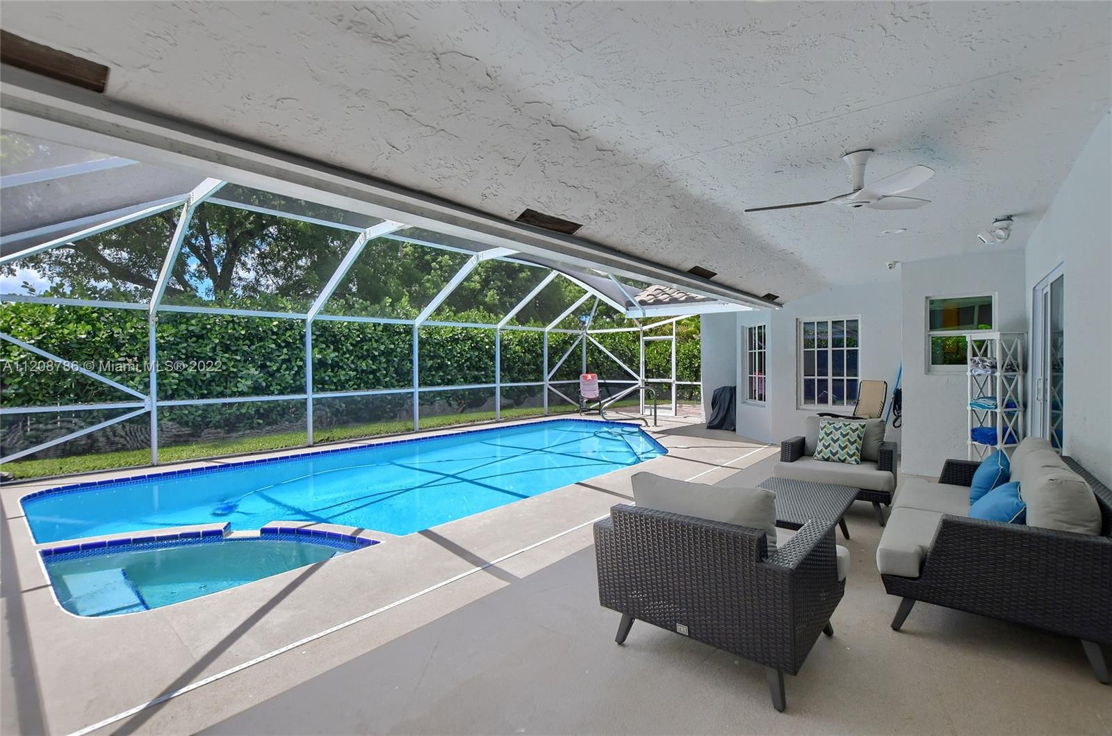 9580 Carousel Circle South Boca Raton, FL 33434 - Photo 30 of 35 a view of swimming pool with seating area and roof