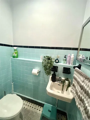 a bathroom with a sink mirror and toilet