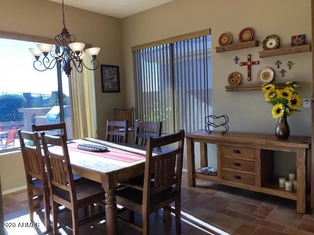 a view of a dining room with furniture and chandelier