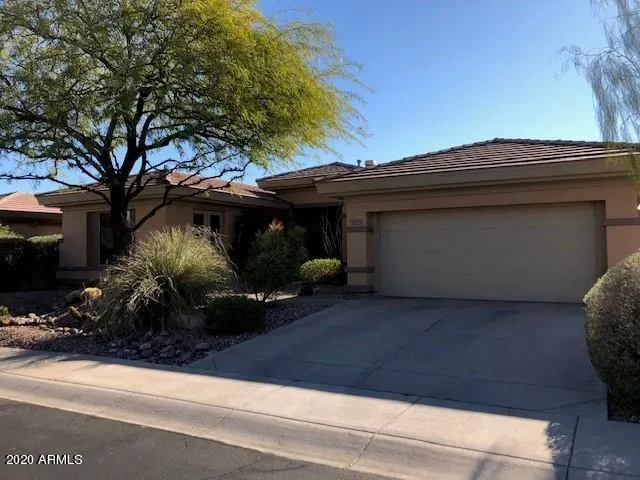 a view of a house with a large window and plants