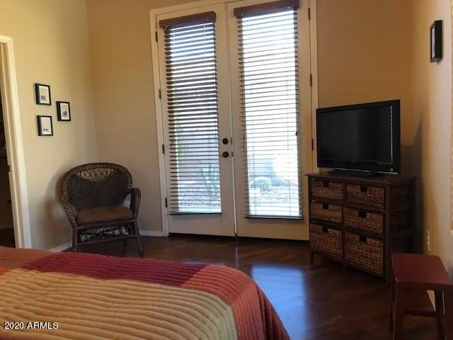 a bedroom with a bed and a flat screen tv