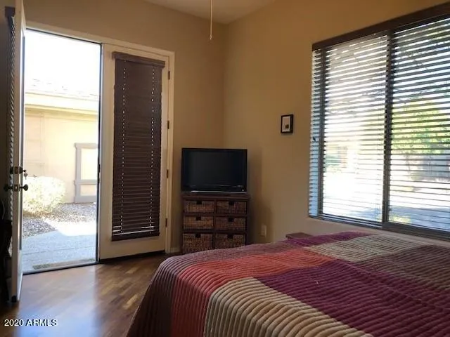 a bedroom with a bed and a television