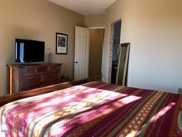 a bedroom with a bed and a flat screen tv