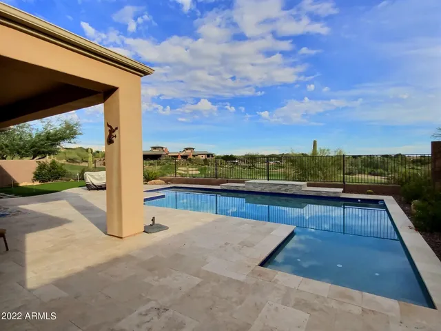 a view of swimming pool with a yard and sitting area