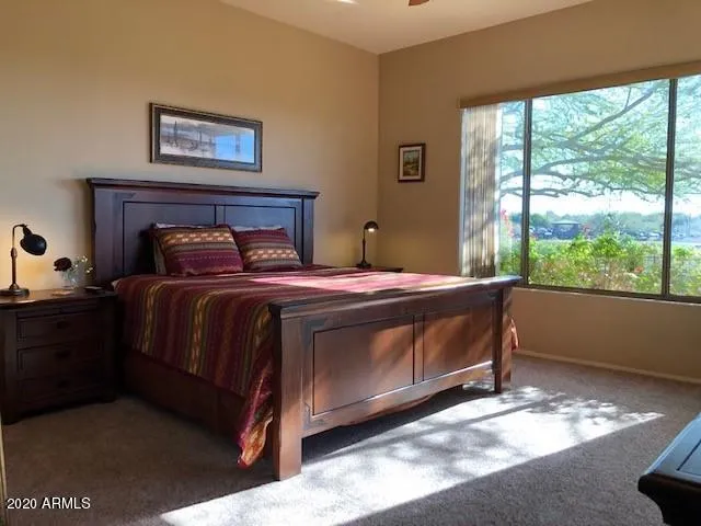 a bedroom with a bed and a large window