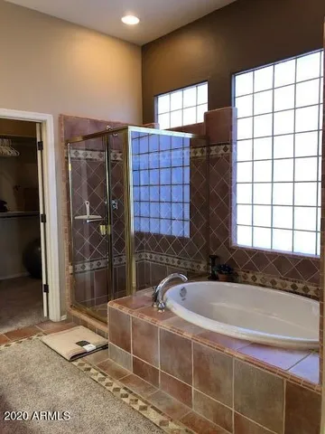 a bathroom with a bathtub and a shower